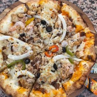 Pizza Cooking On Charcoal